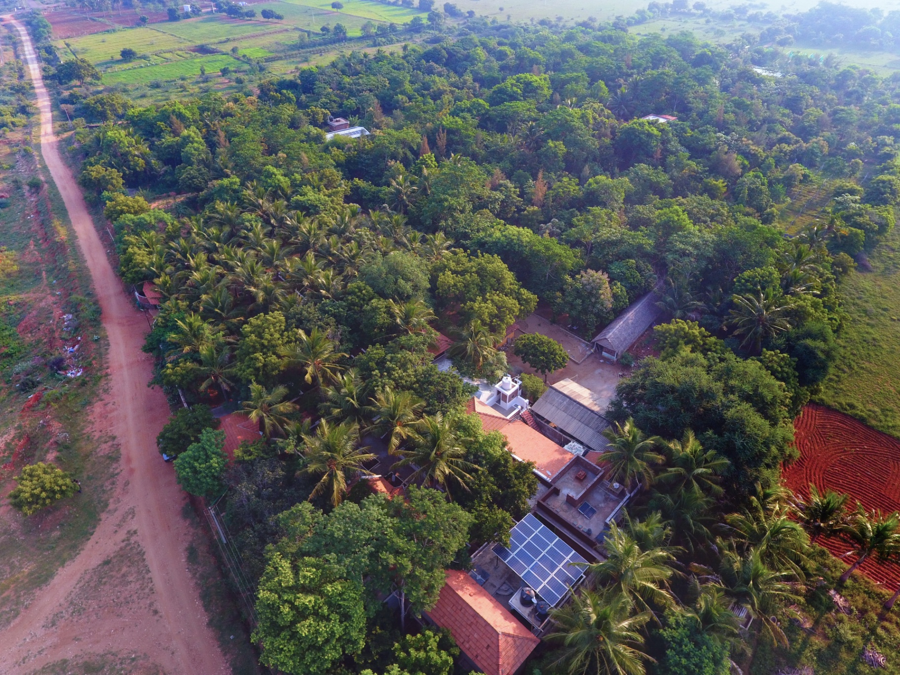 Aerial view of Darshan Ayurveda Hospital campus amid groves in Mayanur, Karur